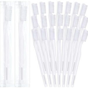 A set of white plastic pipettes with protective caps.